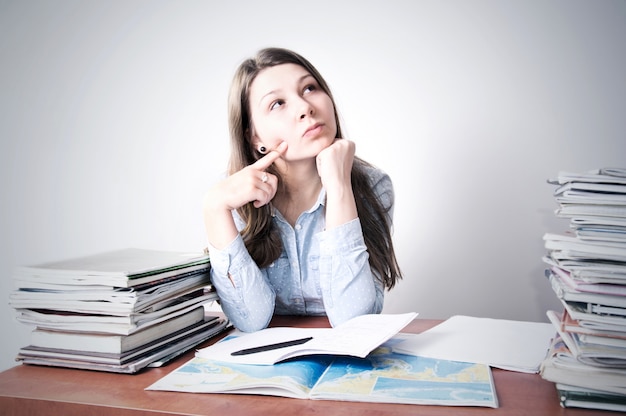 Free photo cute smart young girl studying.