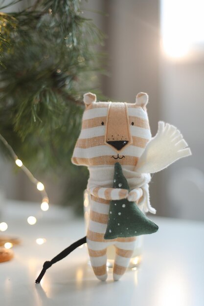 Cute soft toy tiger with decorations on a cozy christmas or new year background symbol of 2022