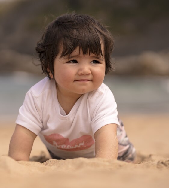 Cute Spanish baby on a sandy beach