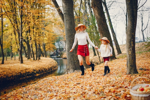 Cute and stylish family in a autumn park