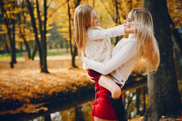 Cute and stylish family in a autumn park