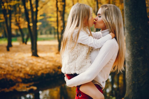 Cute and stylish family in a autumn park