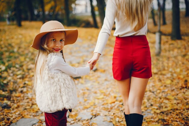 Cute and stylish family in a autumn park