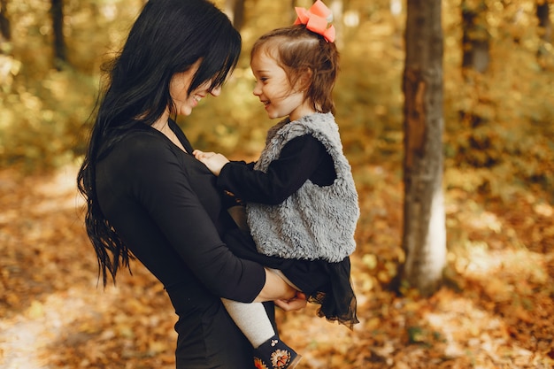 Cute and stylish family in a autumn park