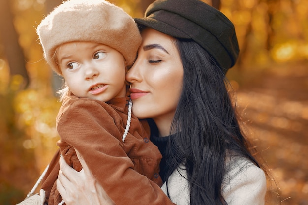 Cute and stylish family in a autumn park