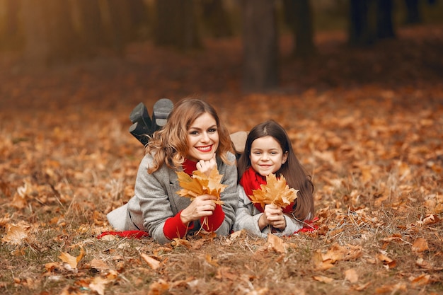 Famiglia carina ed elegante in un parco in autunno