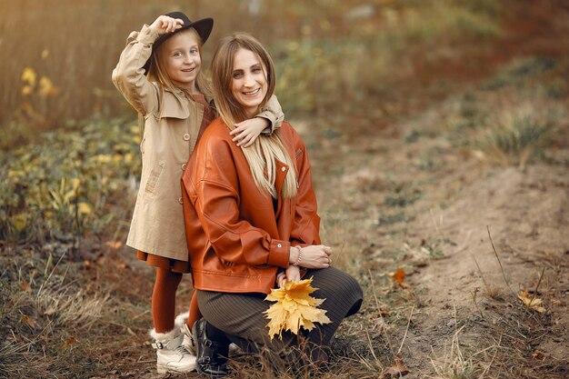 Cute and stylish family in a autumn park