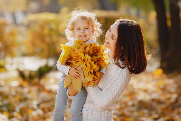 Cute and stylish family in a autumn park