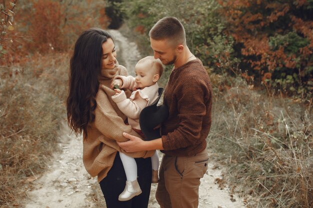 Cute and stylish family playing in a autumn field