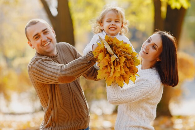 Cute and stylish family playing in a autumn field