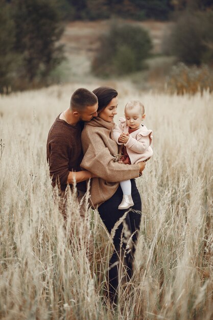 Cute and stylish family playing in a field