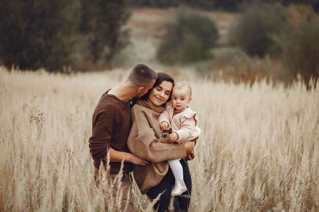 Cute and stylish family playing in a field