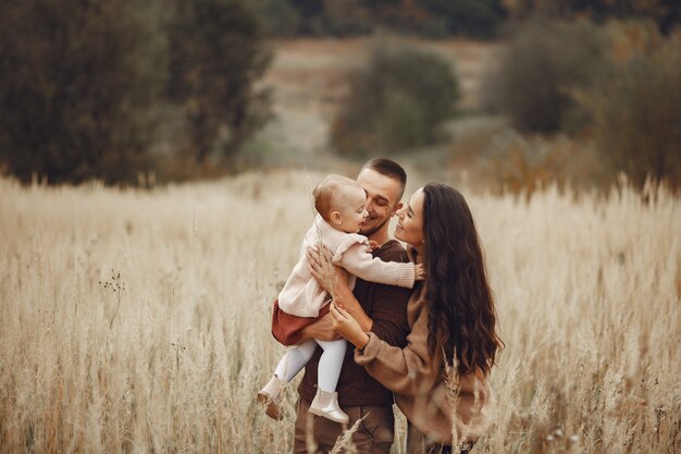 Cute and stylish family playing in a field