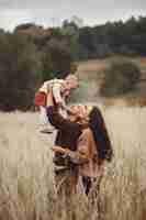 Free photo cute and stylish family playing in a field