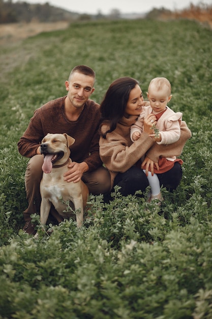 Cute and stylish family playing in a field