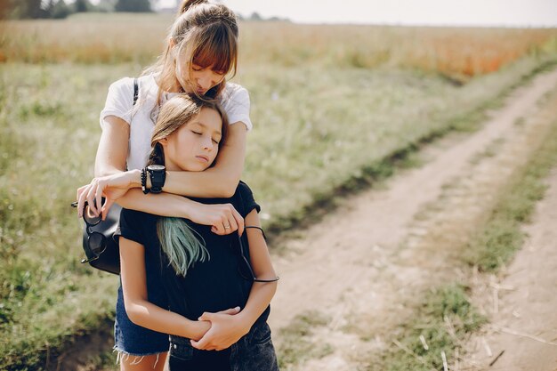 Cute and stylish family in a summer field