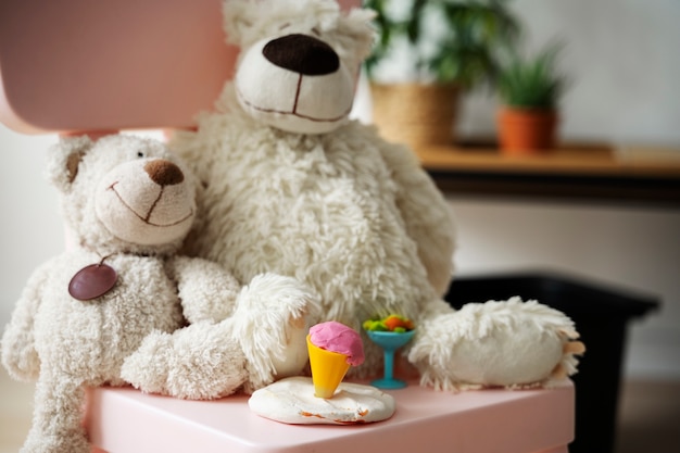 Cute teddy bears on chair with playdough