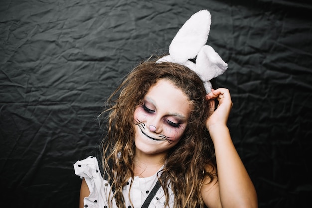 Cute teen girl in rabbit face paint