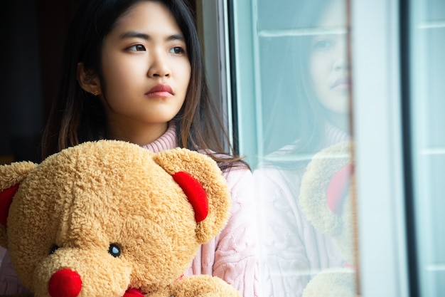 Cute teenage with large teddy bear