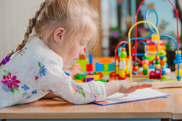 Cute toddler girl with papers