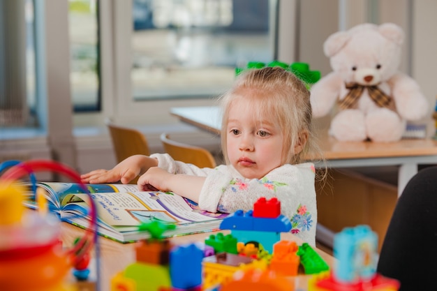 Cute toddler looking away at book