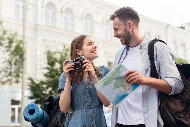 Cute tourist couple with map and camera