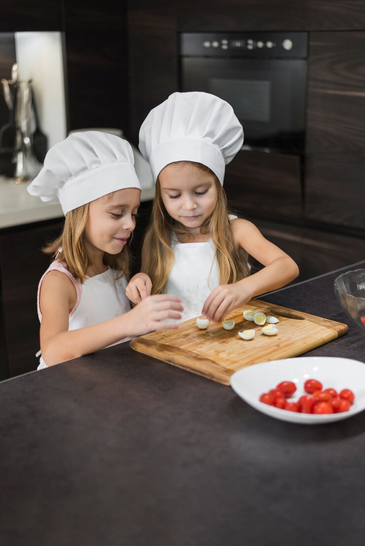 Free Photo cute two siblings preparing food in kitchen