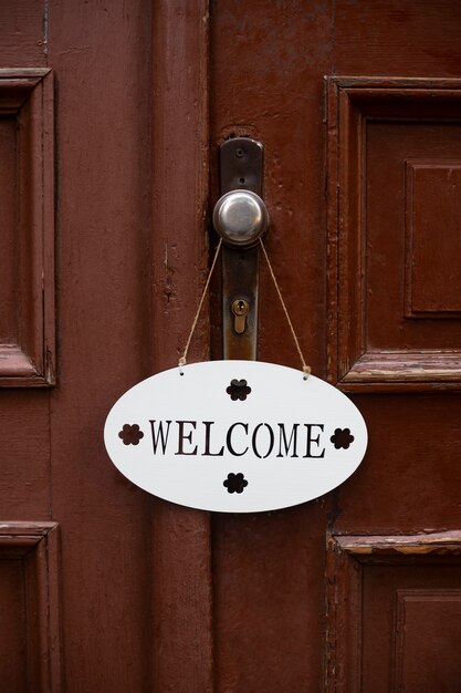 Cute welcome sign on wooden door