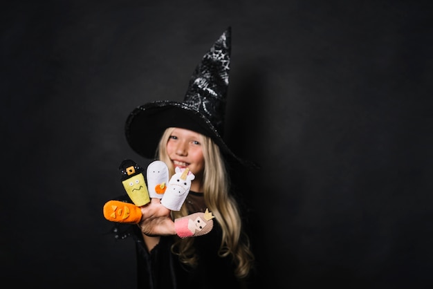 Cute witch with Halloween toys