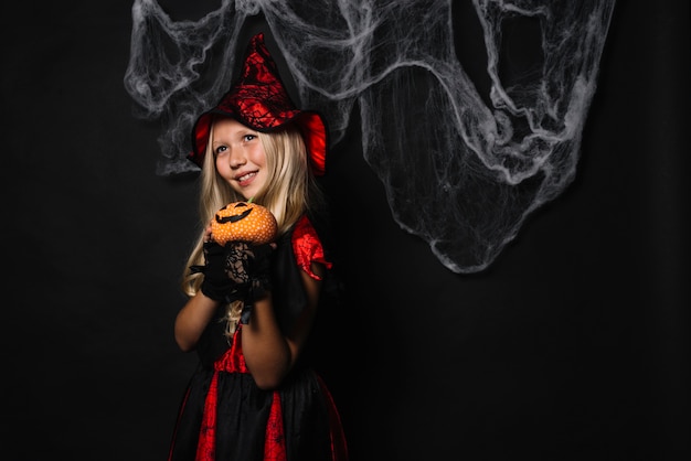 Cute witch with jack-o-lantern