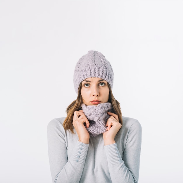 Cute woman in adjusting scarf