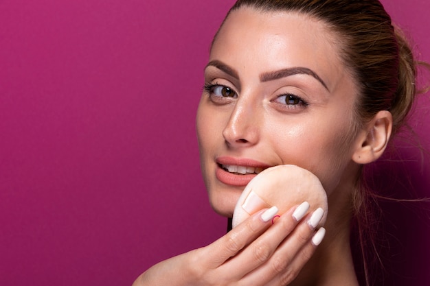 Cute woman holding beauty blender