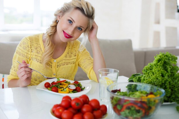 cute woman at home with salad