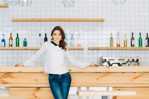 Cute woman near bar counter in cafe