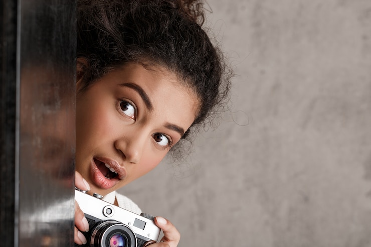 Free Photo cute woman paparazzi taking photos secretly from corner