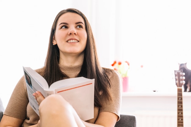 Cute woman reading book