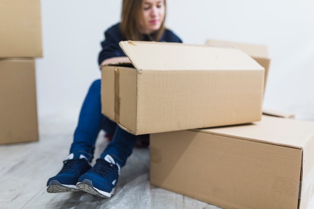 Cute woman signing boxes