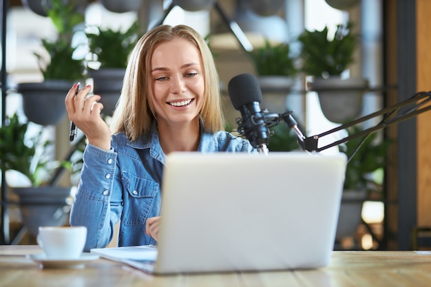 Cute woman telling some information for listeners on radio