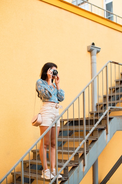 Cute woman with black hair taking a photo