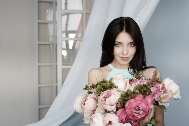 Cute woman with floral bouquet