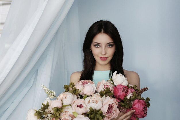 Cute woman with floral bouquet