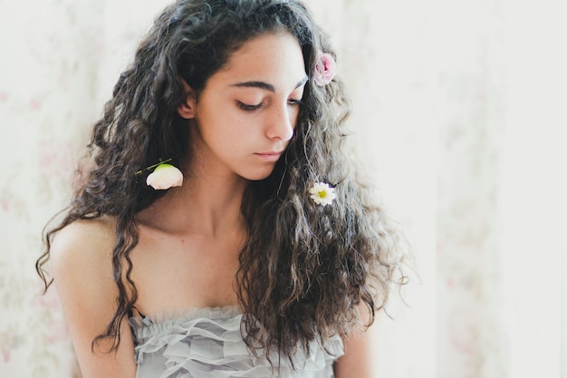 Foto gratuita donna carina con fiori nei capelli