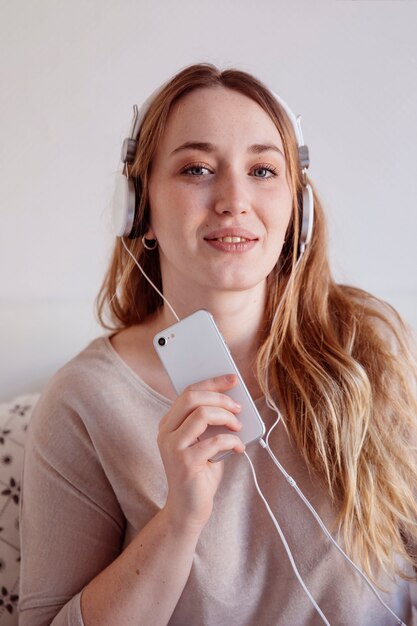 Cute woman with smartphone and headphones