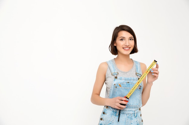 Cute woman with tape measure renovate house