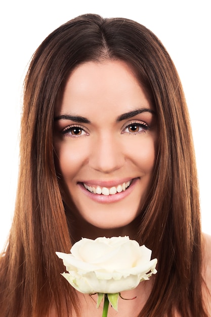 Cute woman with white rose in studio