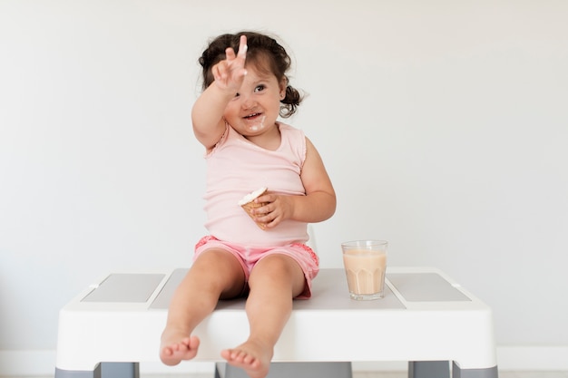 Cute young baby girl with ice cream