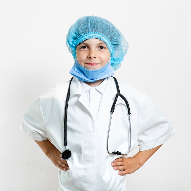 Cute young boy doctor with hair net