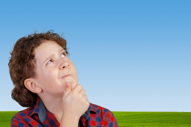 Free Photo cute young boy thinking