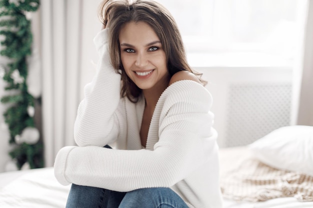 Free photo cute young cozy woman indoor portrait