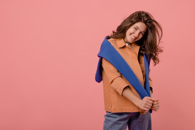 Cute young fairskinned brunette girl smiles modestly at camera against background with space for text Good mood concept